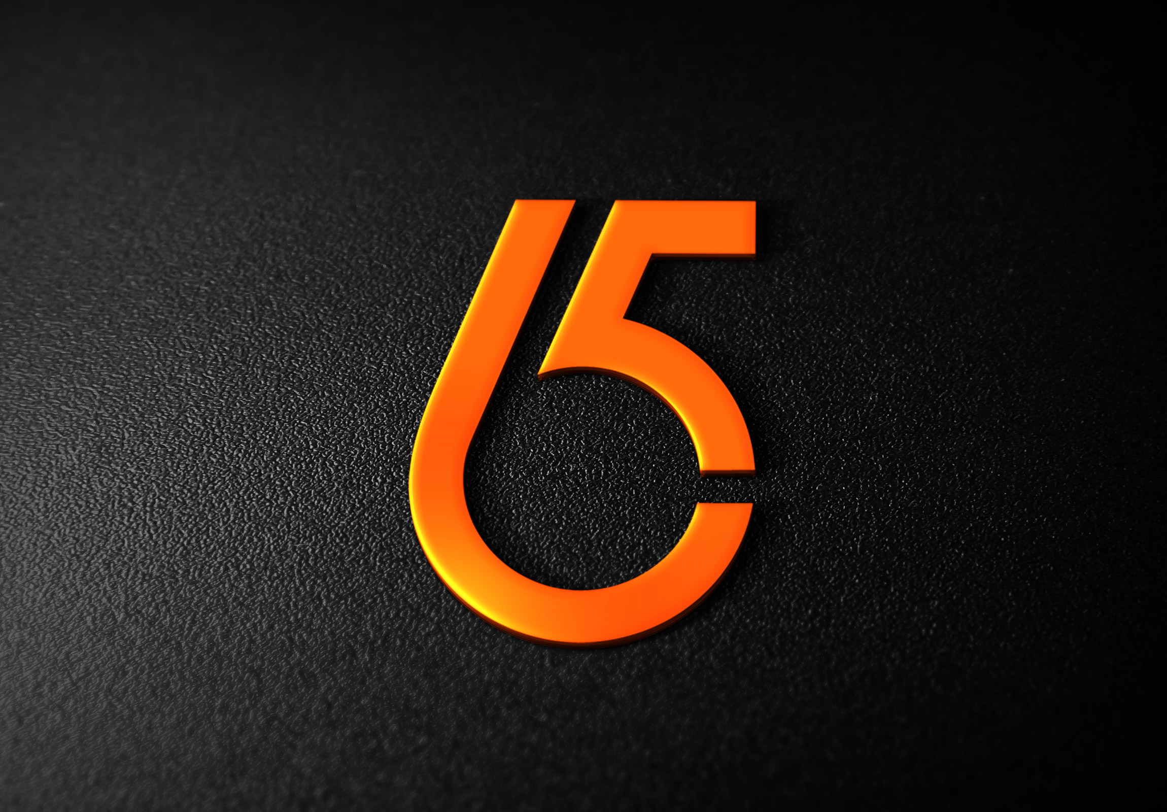 Close up of a number five on a black surface.