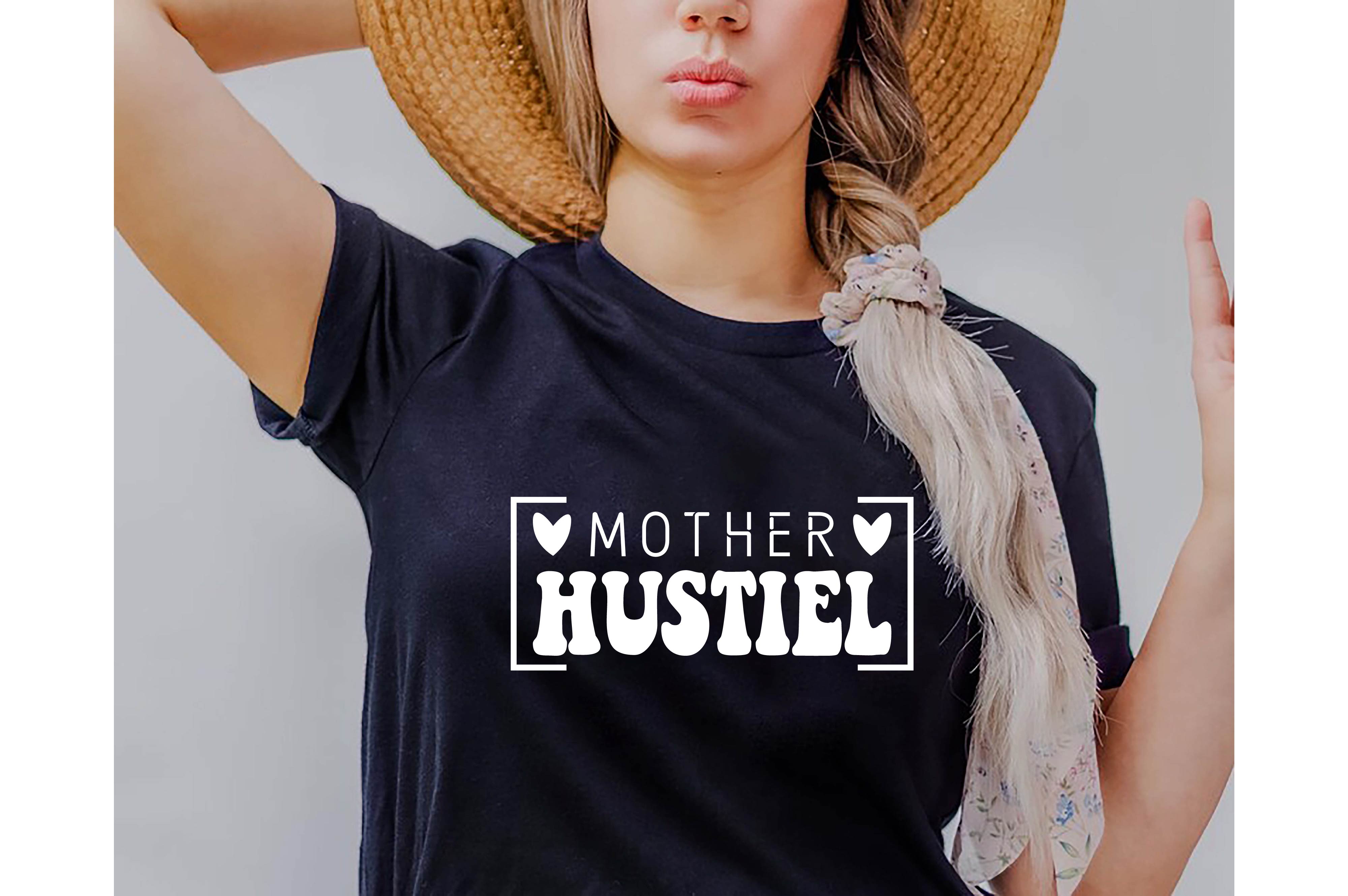 Woman wearing a hat and a t - shirt that says mother hustlel.