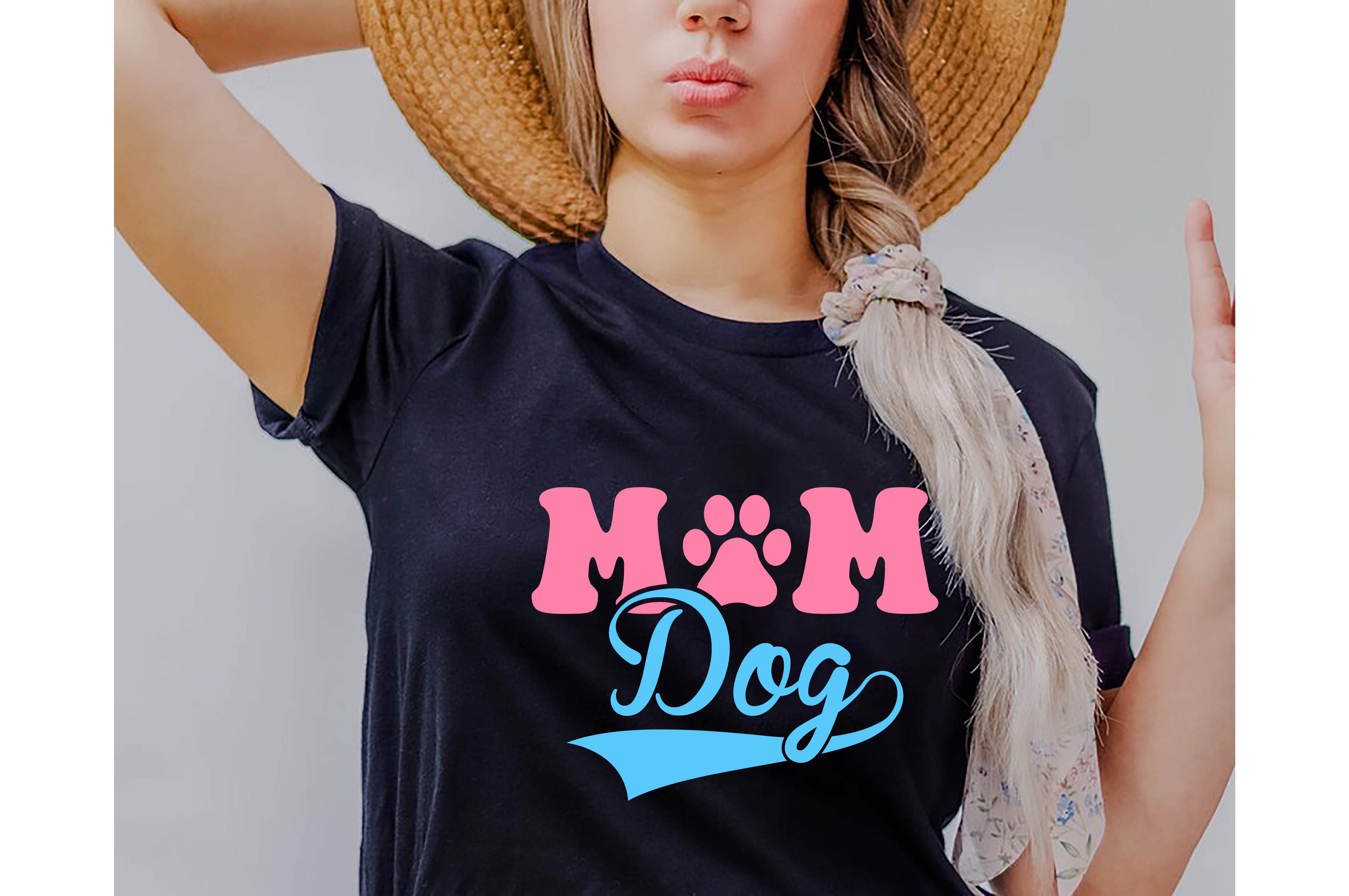 Woman wearing a mom dog shirt with a hat on her head.