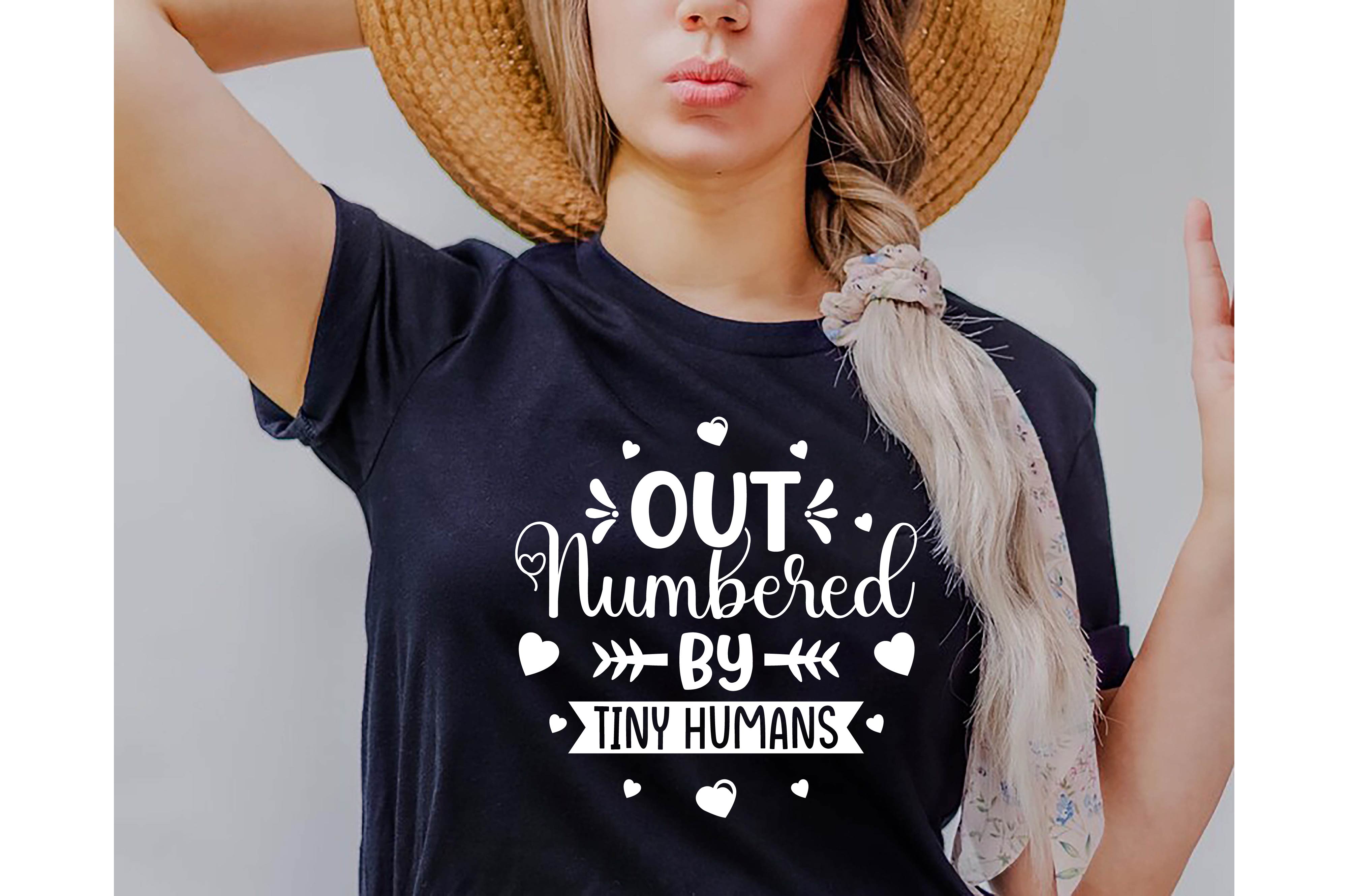 Woman wearing a hat and a t - shirt that says out numbered by tiny.
