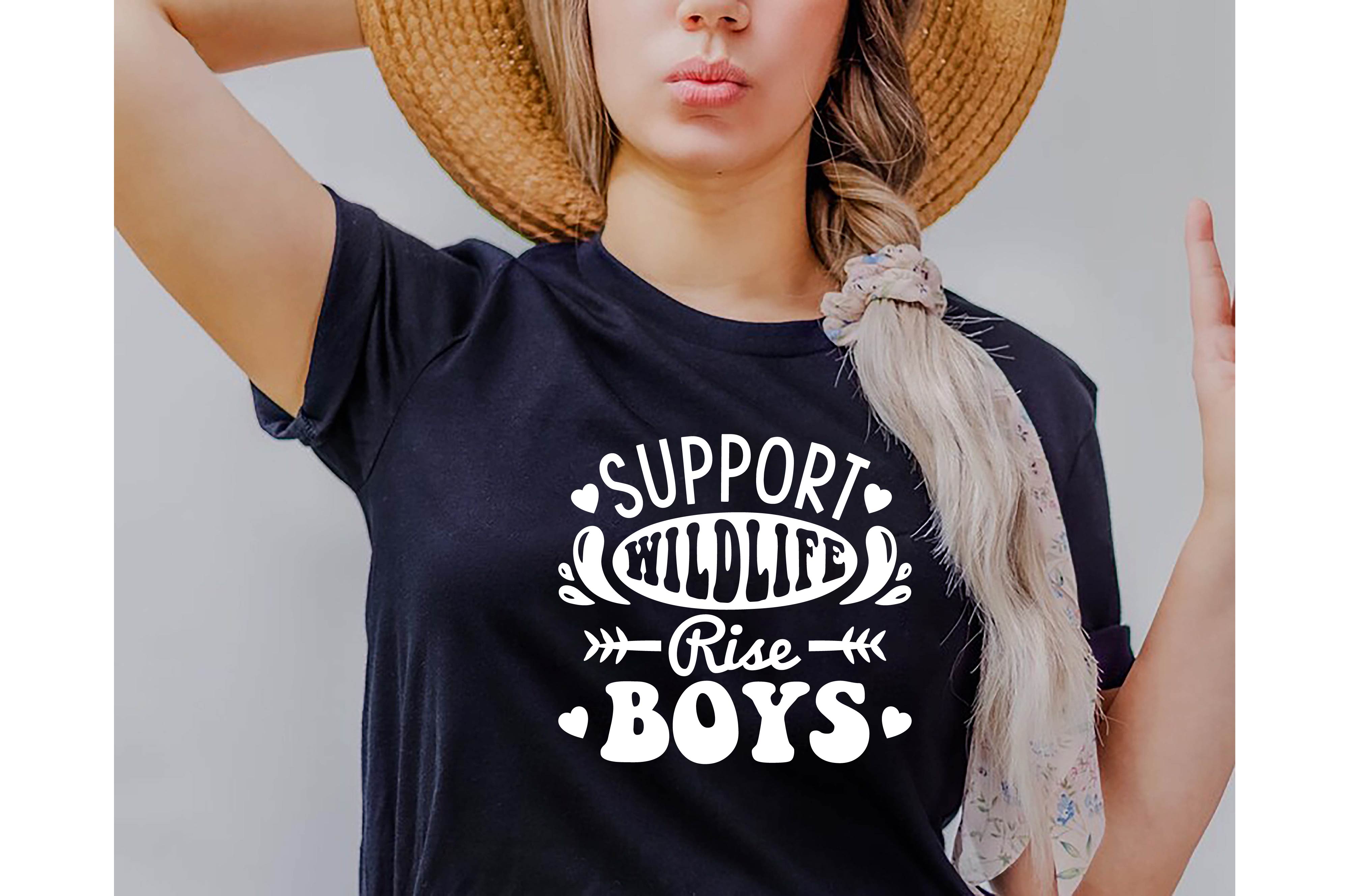 Woman wearing a t - shirt that says support child rise boys.