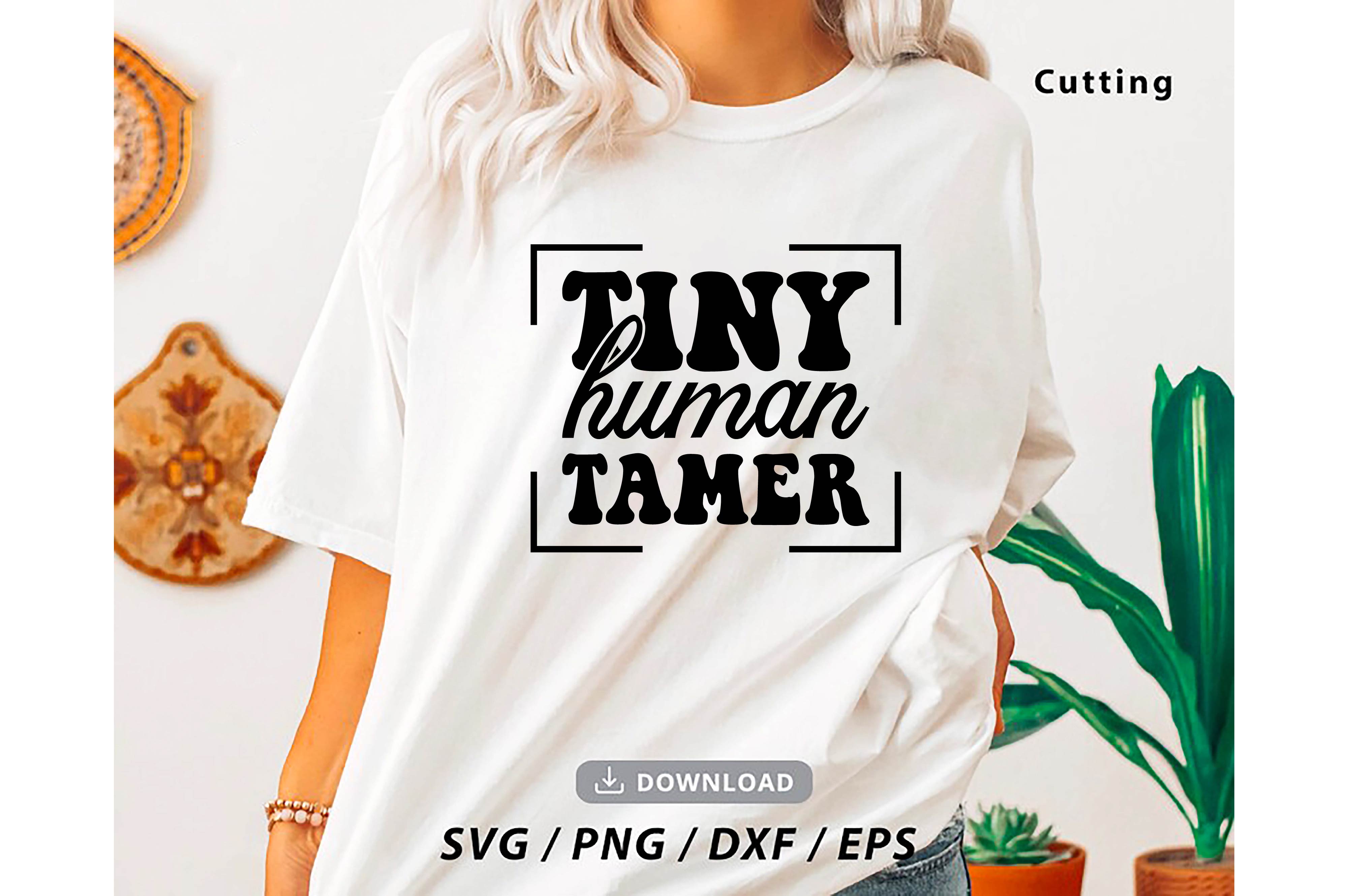 Woman wearing a t - shirt that says tiny human tamer.