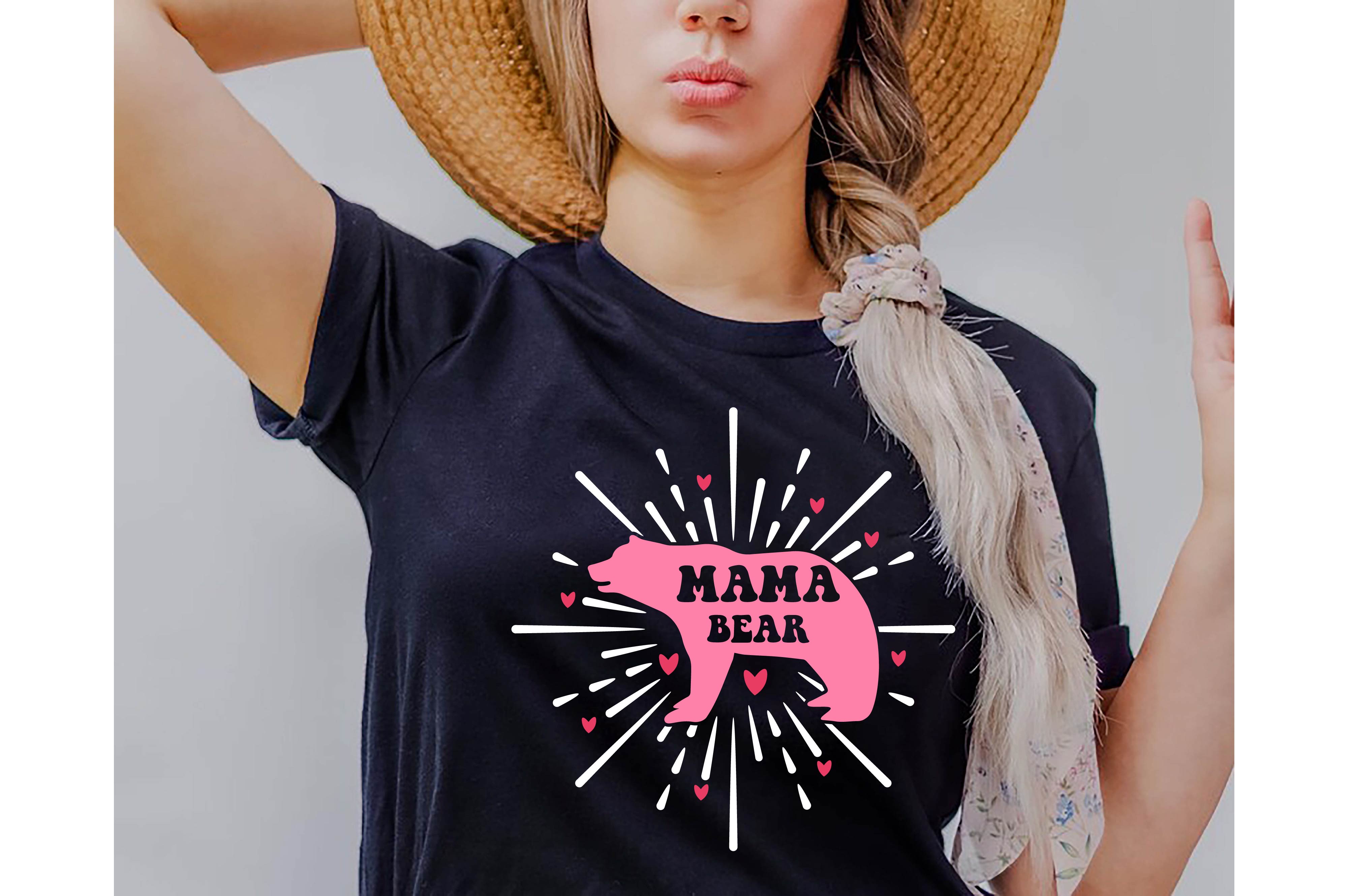 Woman wearing a mama bear t - shirt and a straw hat.