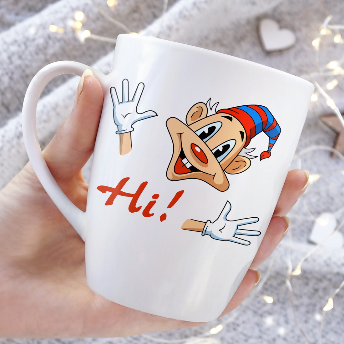 Person holding a coffee mug with a cartoon character on it.