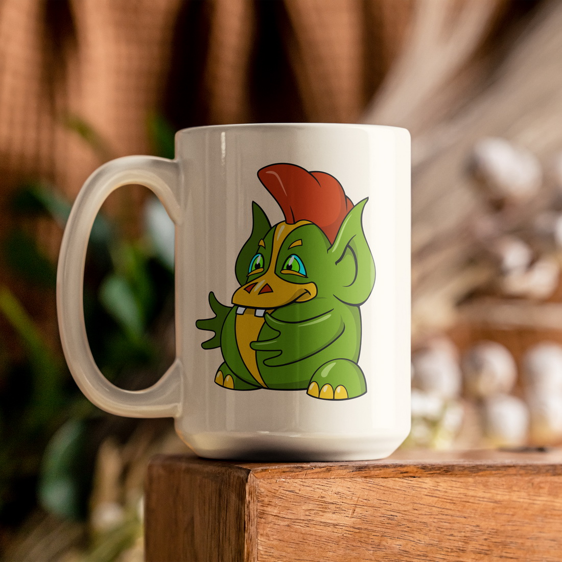 White coffee mug with a green dragon on it.
