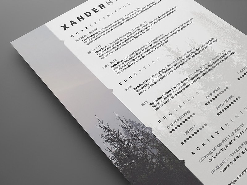 White and black resume with trees in the background.