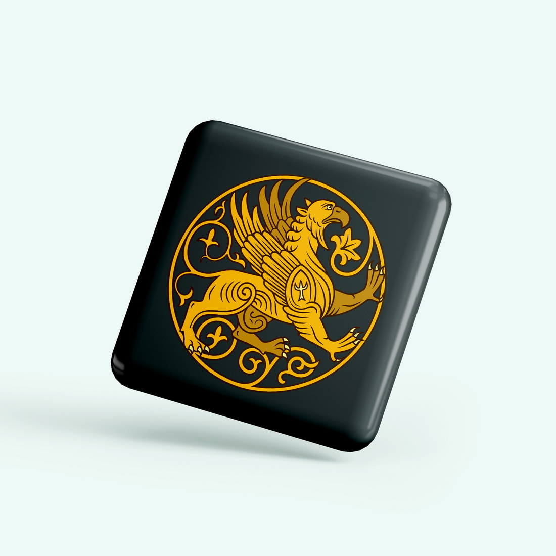 Black square button with a gold design on it.
