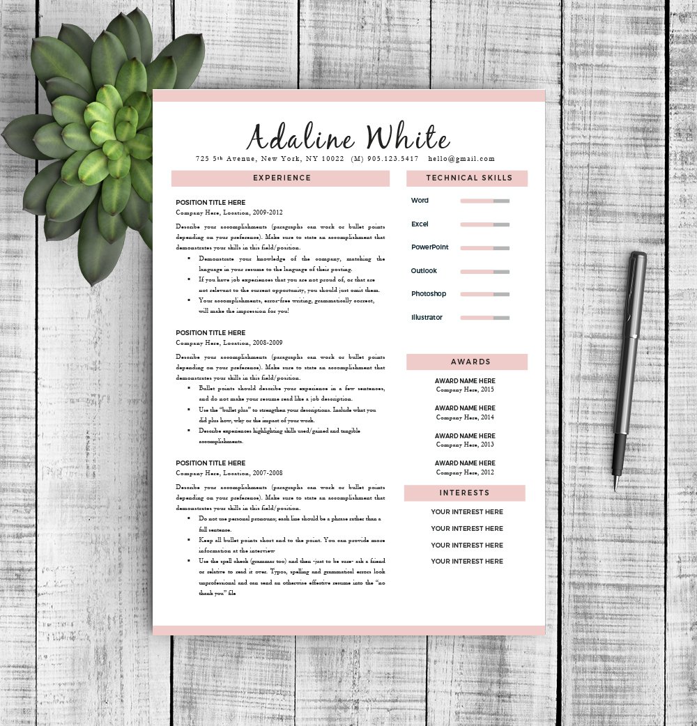 Pink and white resume template on a wooden table.