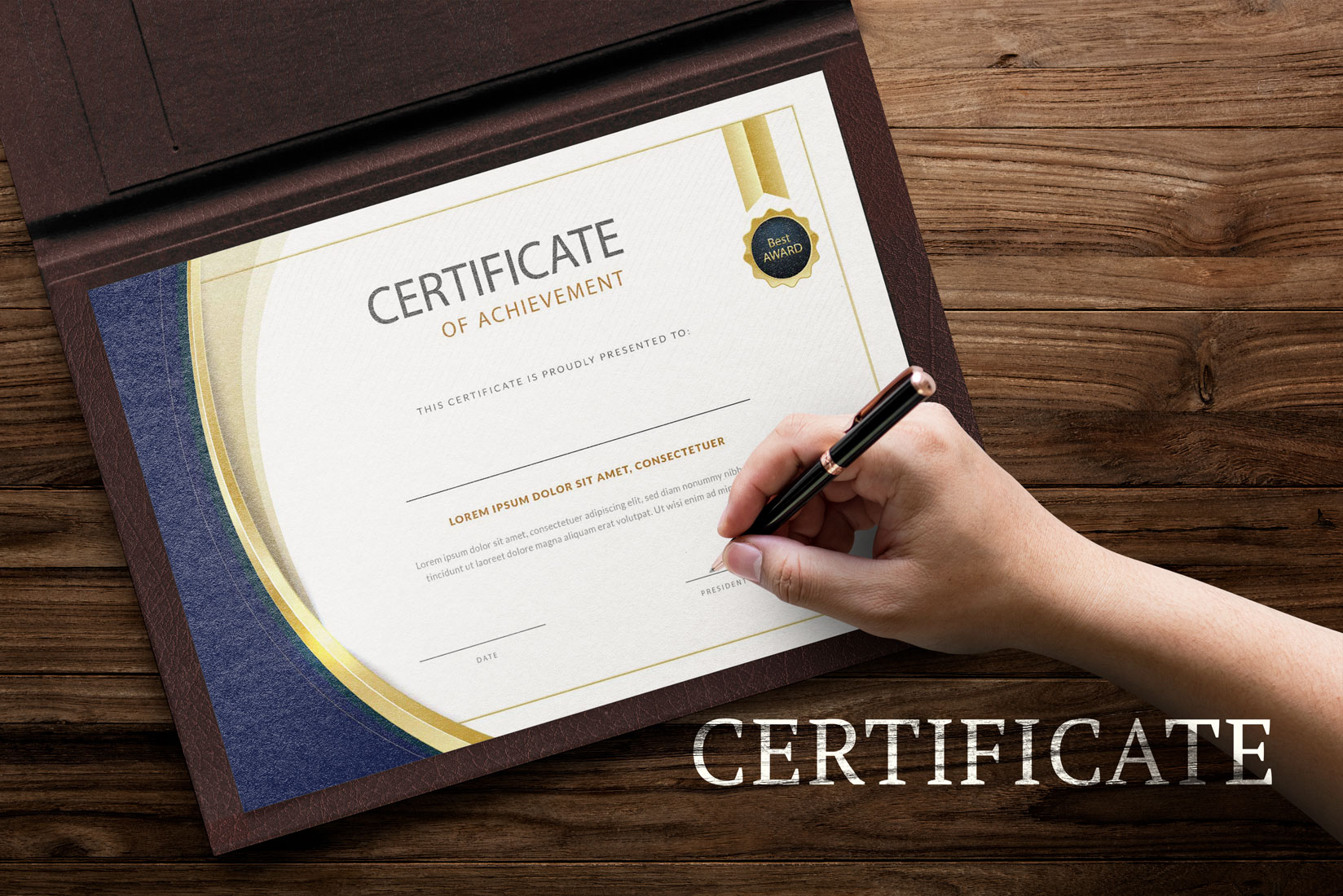 Person holding a pen and writing on a certificate.