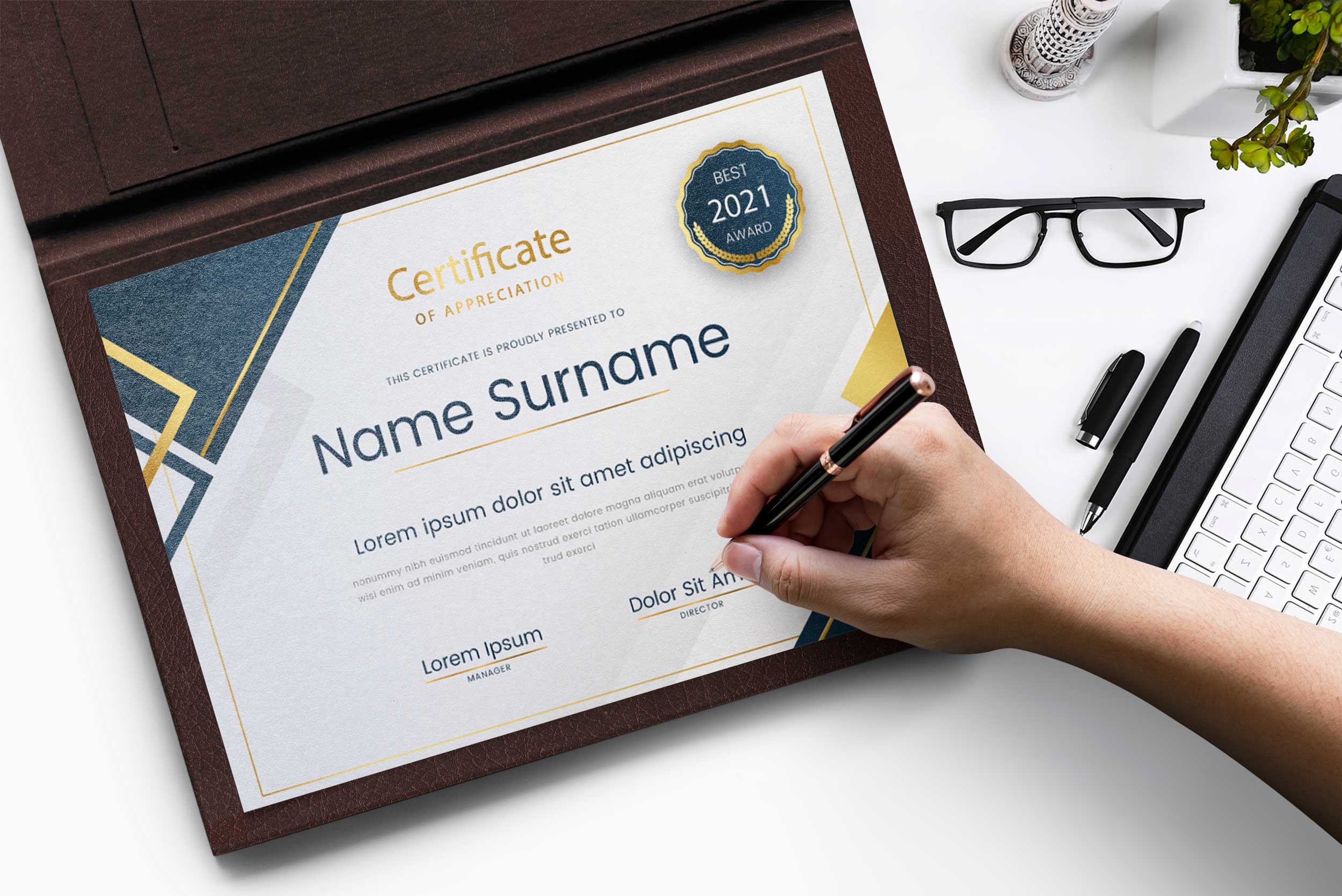 Person holding a pen and writing on a certificate.