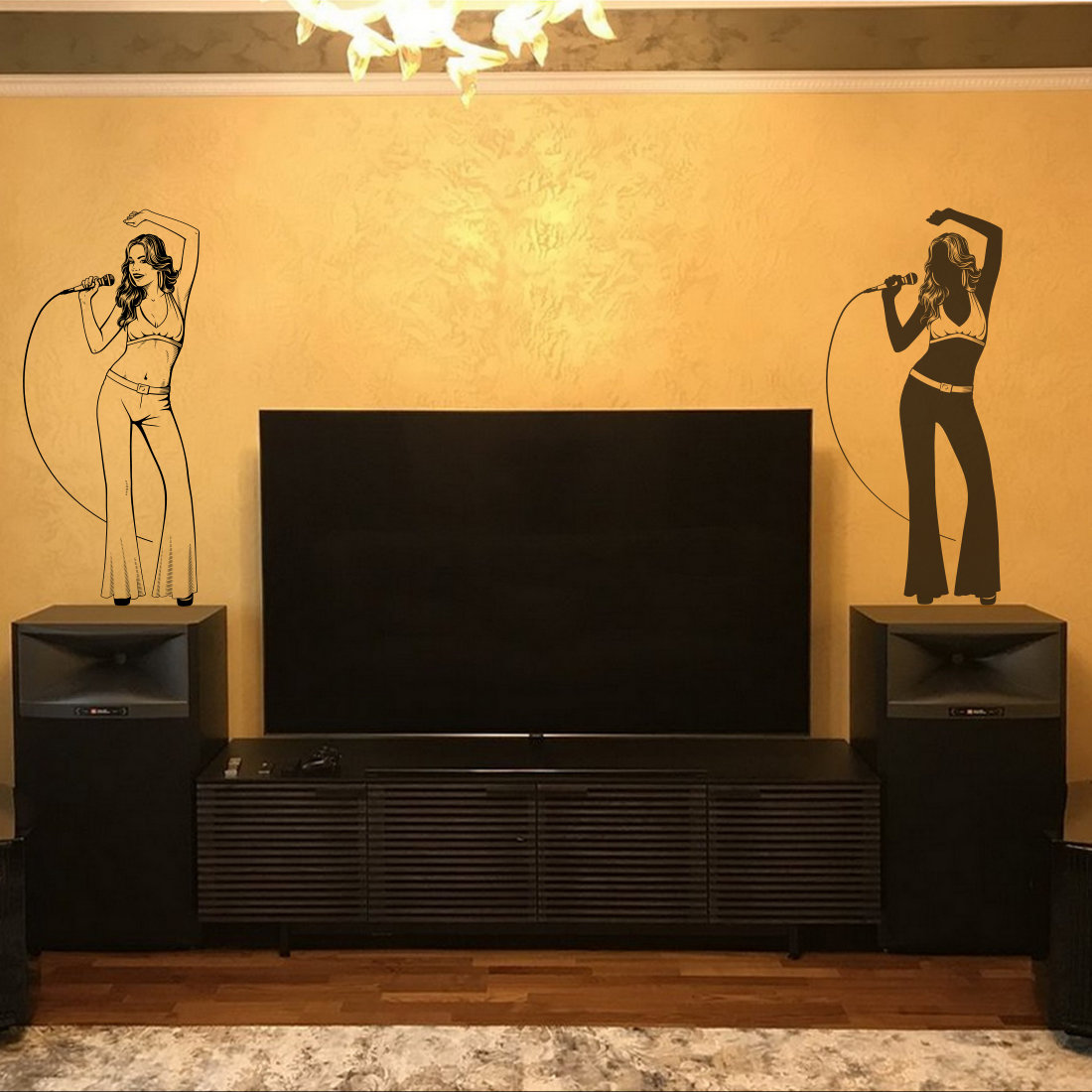 Living room with a television and speakers.