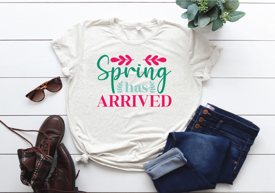 T - shirt that says spring has arrived next to a pair of jeans and.