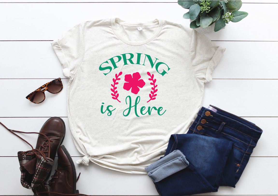 T - shirt that says spring is here next to a pair of jeans and.