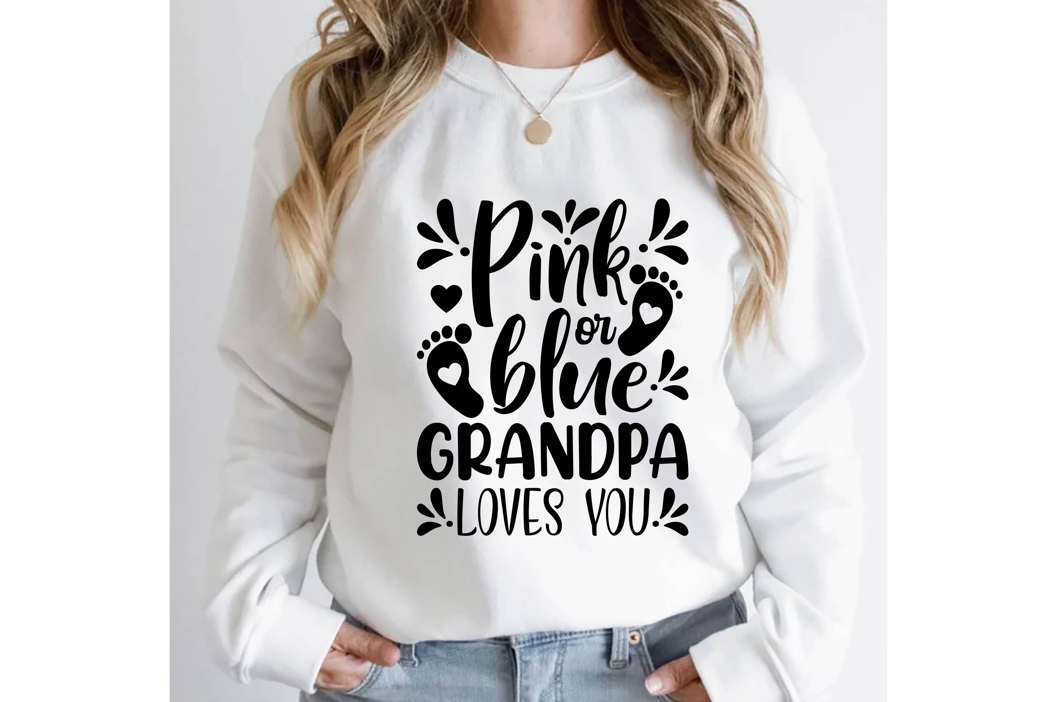Woman wearing a white sweatshirt that says pink is the new blue grandpa loves you.