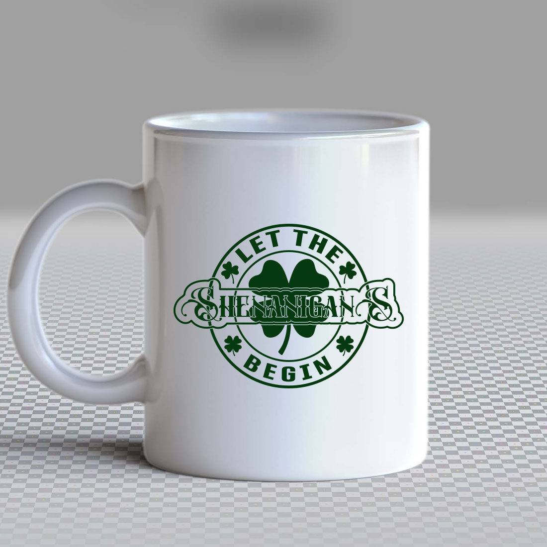White coffee mug with a four leaf clover on it.