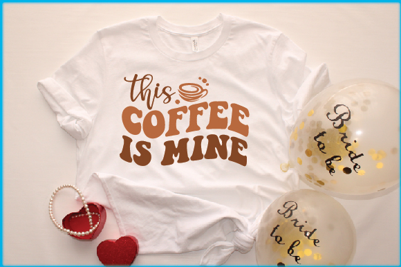 T - shirt that says coffee is mine next to balloons.