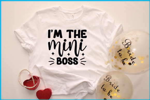 T - shirt that says i'm the mini boss next to balloons and.