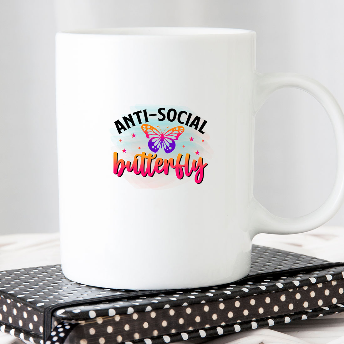 White coffee mug with the words anti - social butterfly on it.