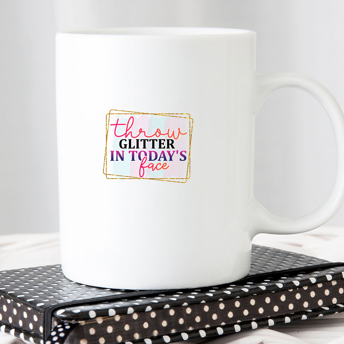 White coffee mug sitting on top of a book.