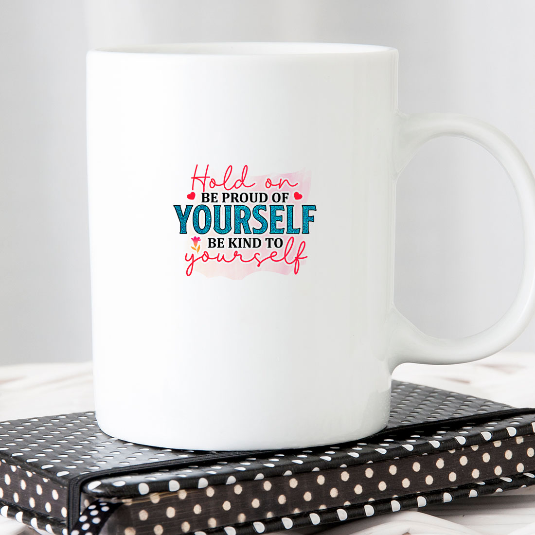 White coffee mug sitting on top of a book.