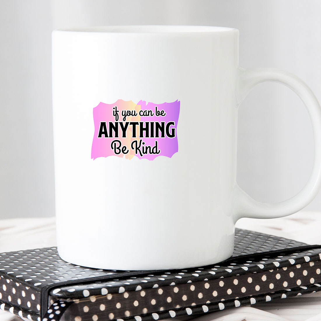 White coffee mug that says if you can be anything be kind.