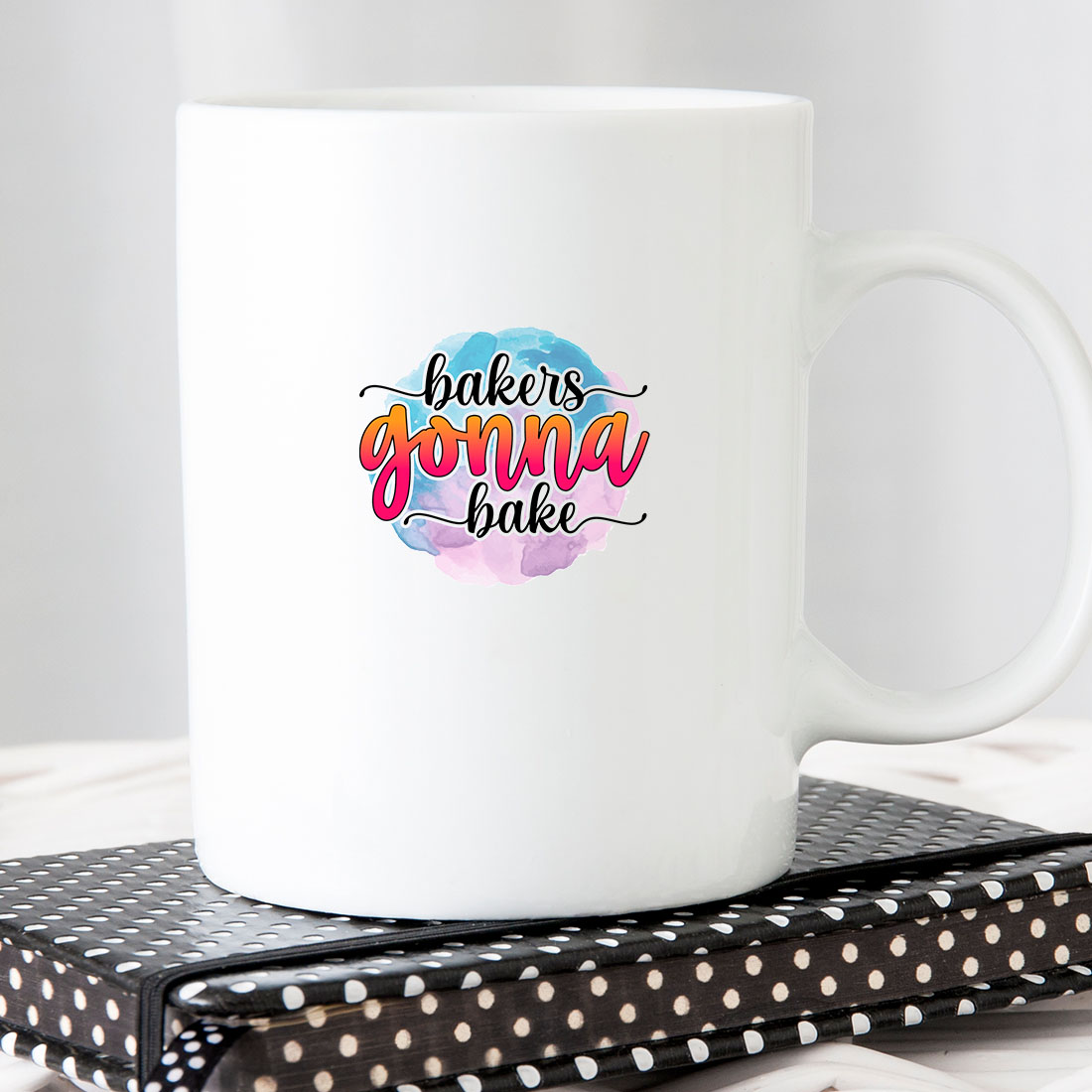 White coffee mug sitting on top of a book.