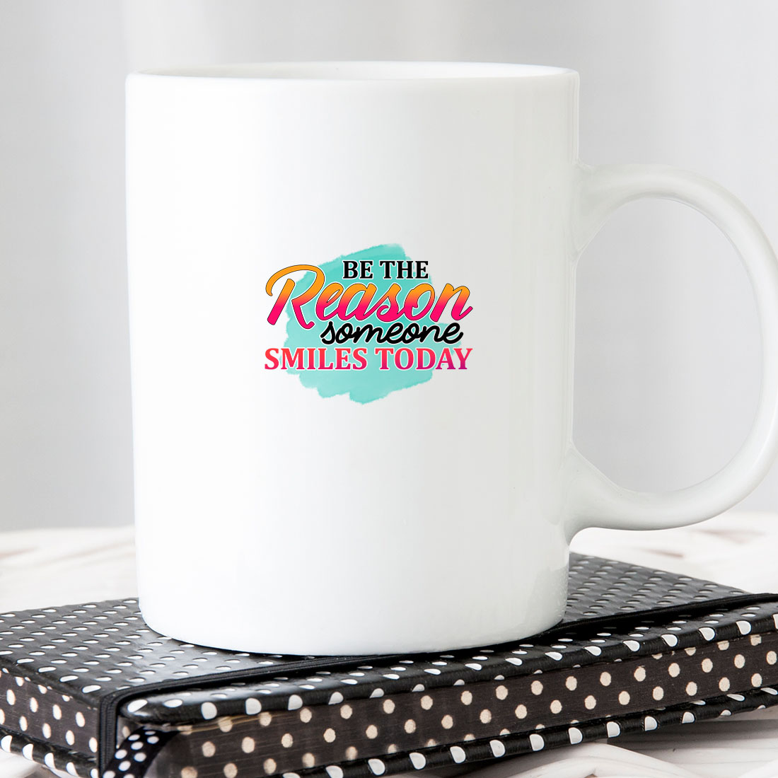 White coffee mug sitting on top of a book.