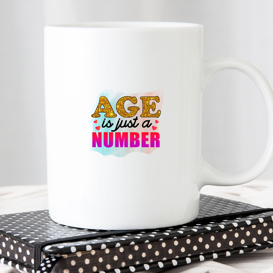 White coffee mug with the words age is just a number on it.