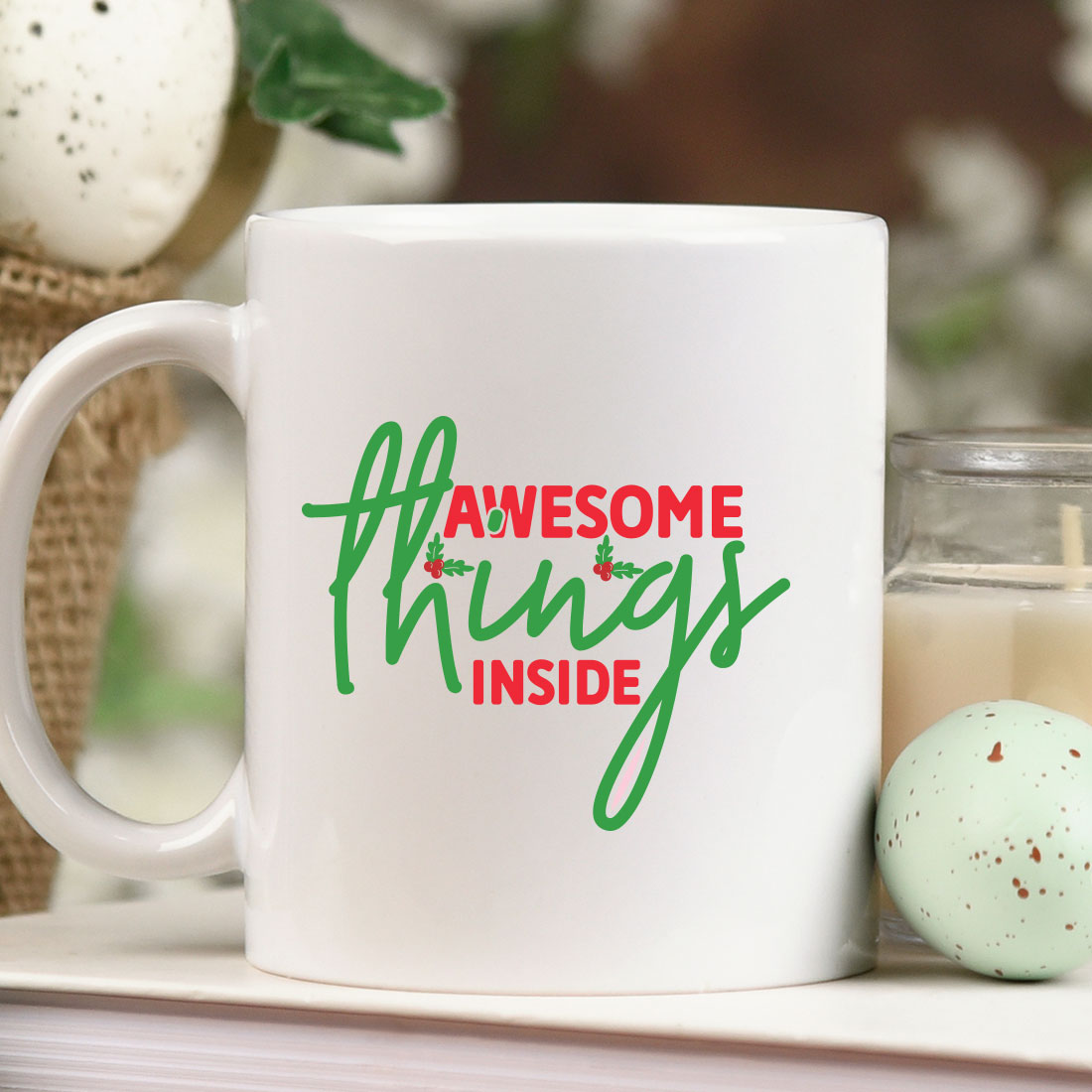 White coffee mug sitting on top of a table next to a candle.