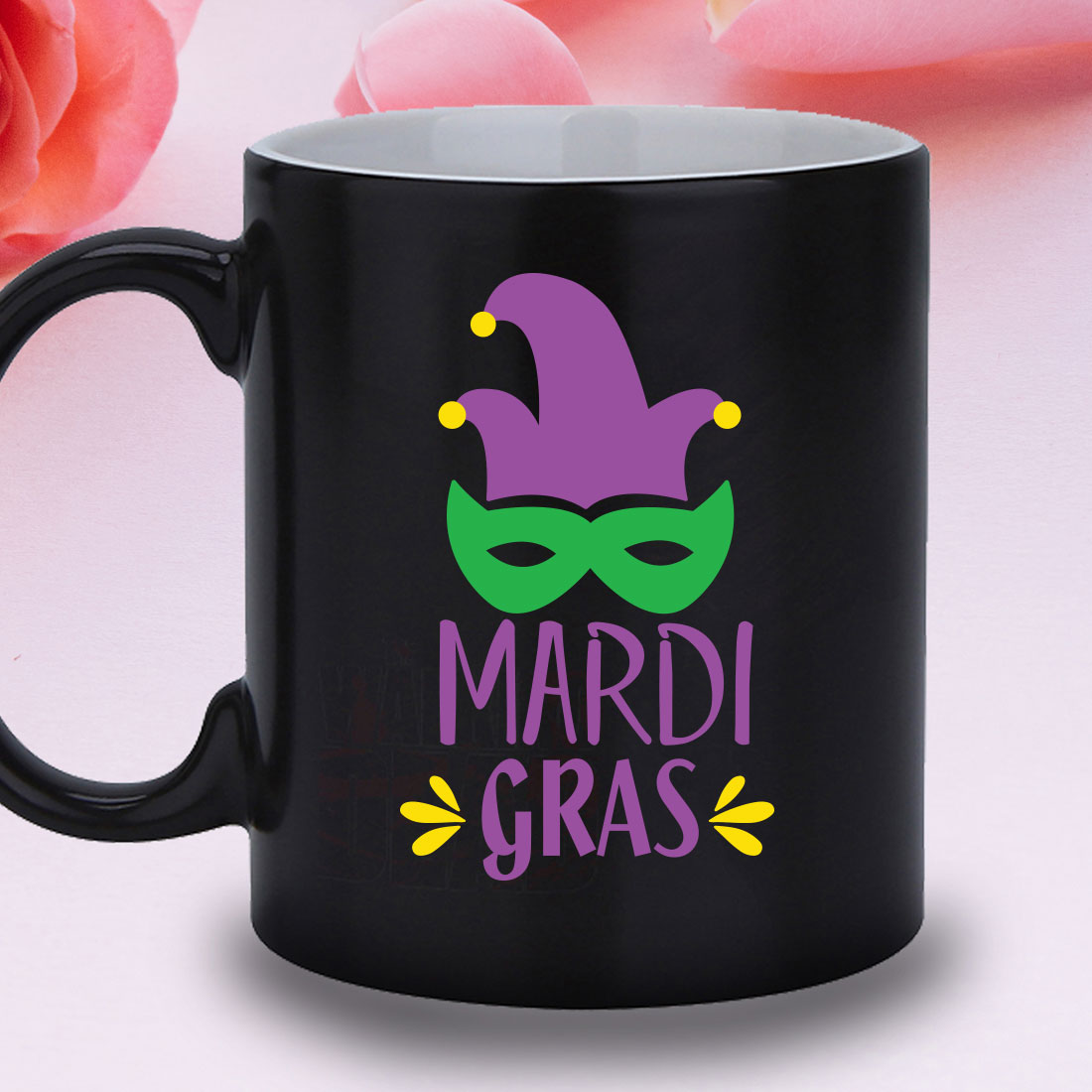Black mug with a mardi gras mask on it.