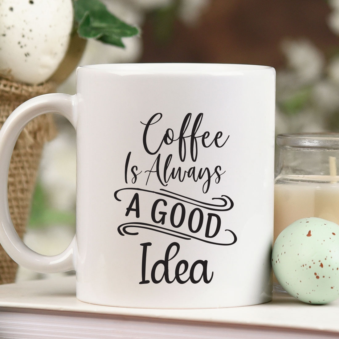 Coffee is always a good idea mug next to a candle.