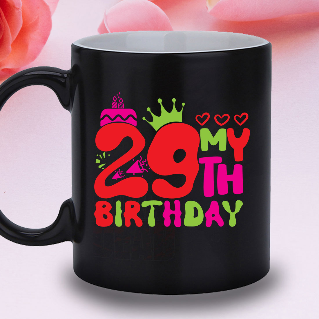 Black coffee mug with a pink rose in the background.