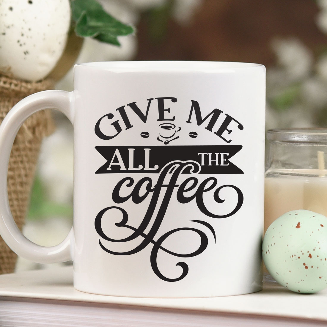 White coffee mug sitting on top of a table next to a candle.