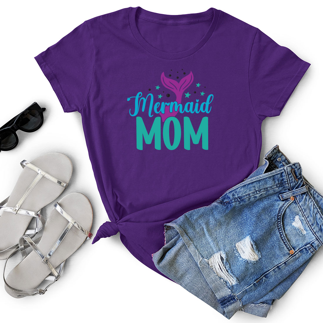 Purple shirt that says mermaid mom next to a pair of shorts.