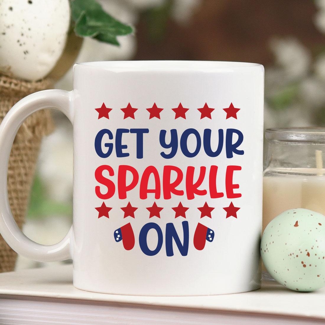 Coffee mug sitting on top of a table next to a candle.