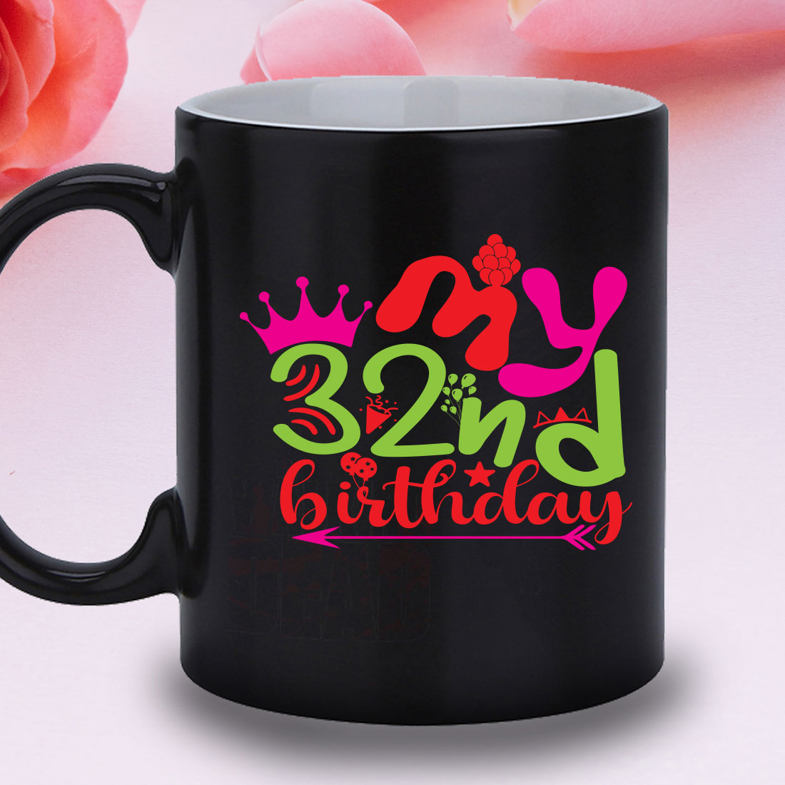 Black coffee mug with a pink rose in the background.