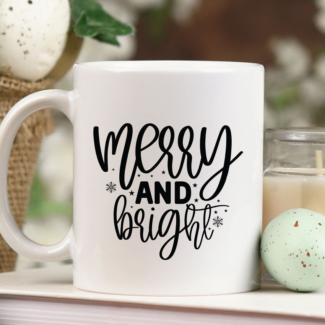 White coffee mug sitting on top of a table next to a candle.