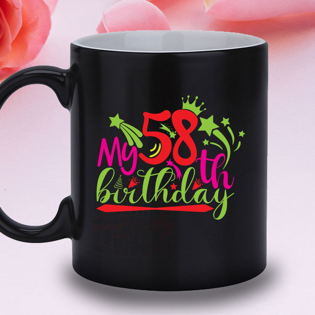 Black coffee mug with a pink rose in the background.