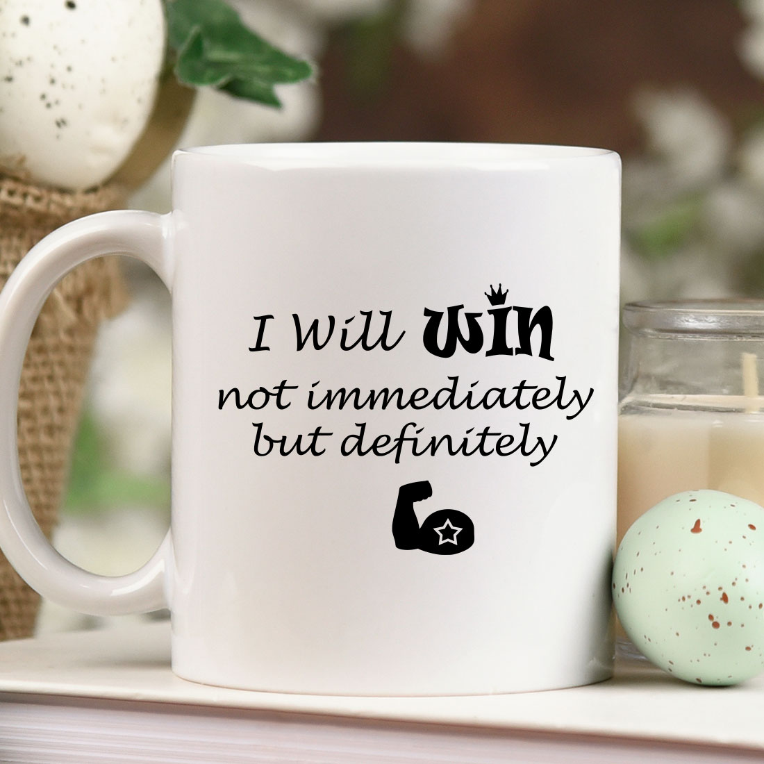 White coffee mug sitting on top of a table next to a candle.