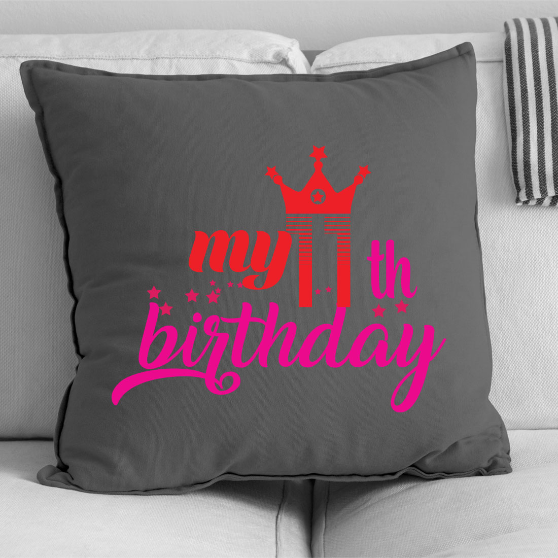 Gray pillow with pink lettering on it.