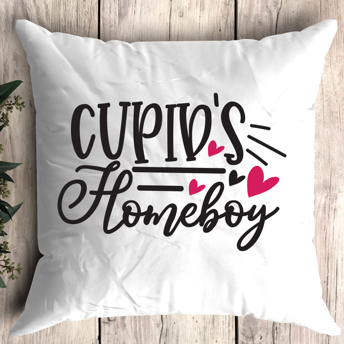 White pillow with the words cupid's homeboy on it.