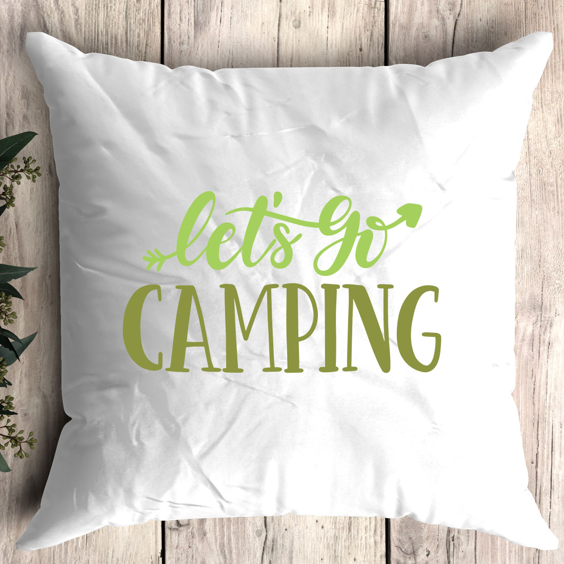 Pillow that says let's go camping on it.