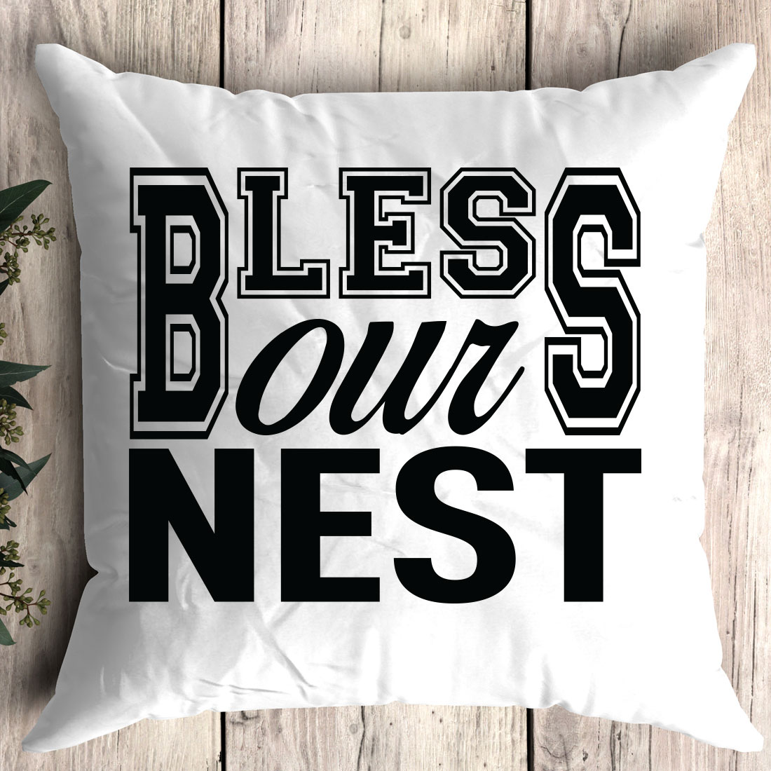 White pillow with the words bliss down nest on it.