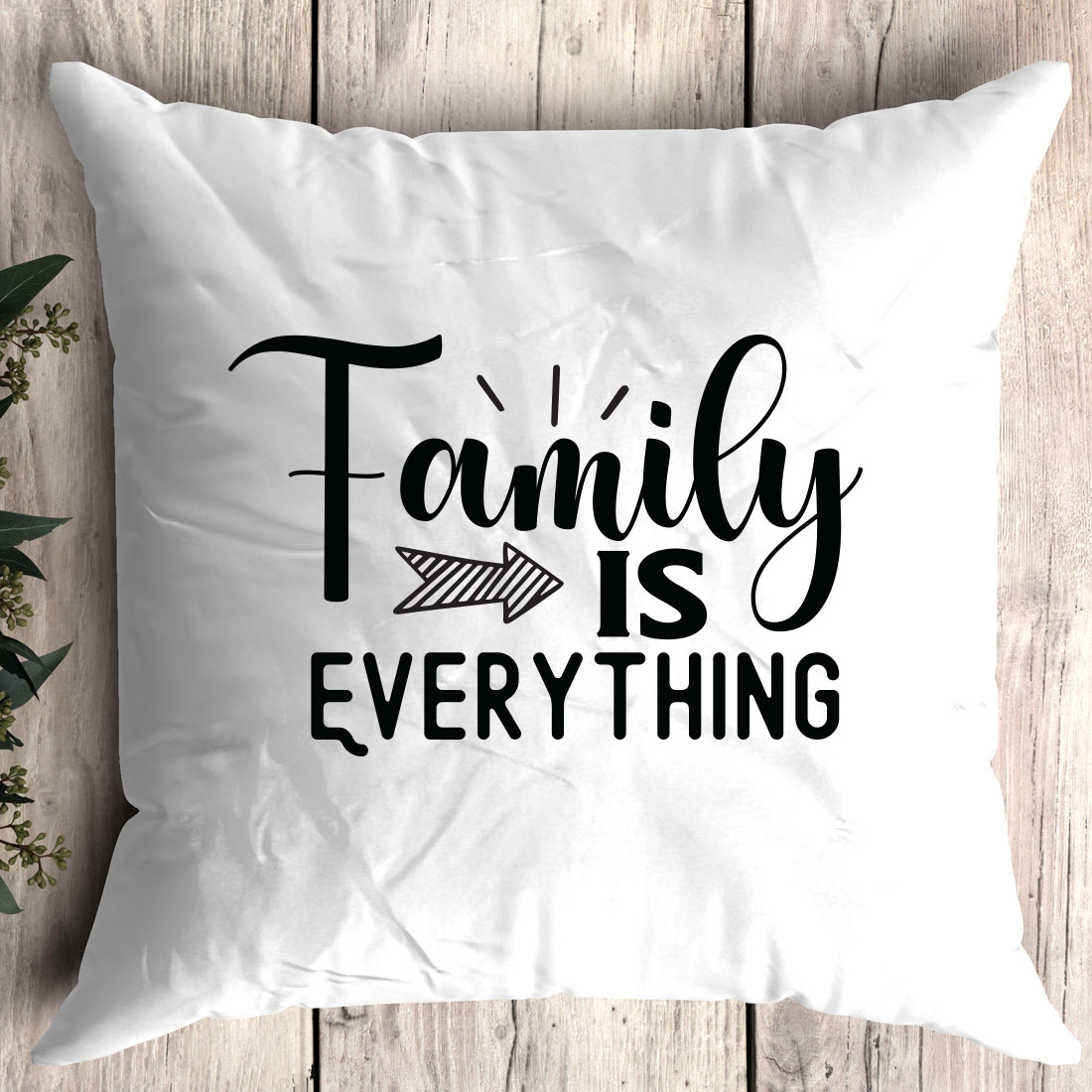 White pillow with the words family is everything on it.