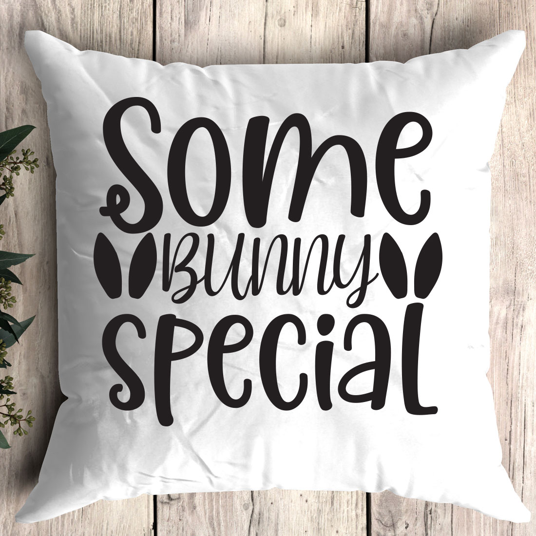 White pillow that says some bunny special on it.