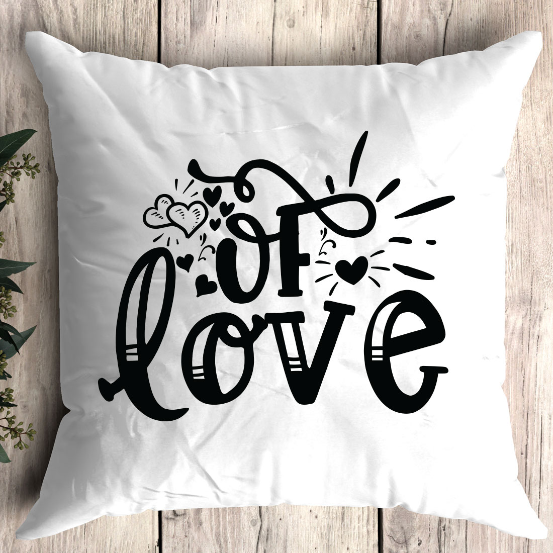 White pillow with the word love printed on it.