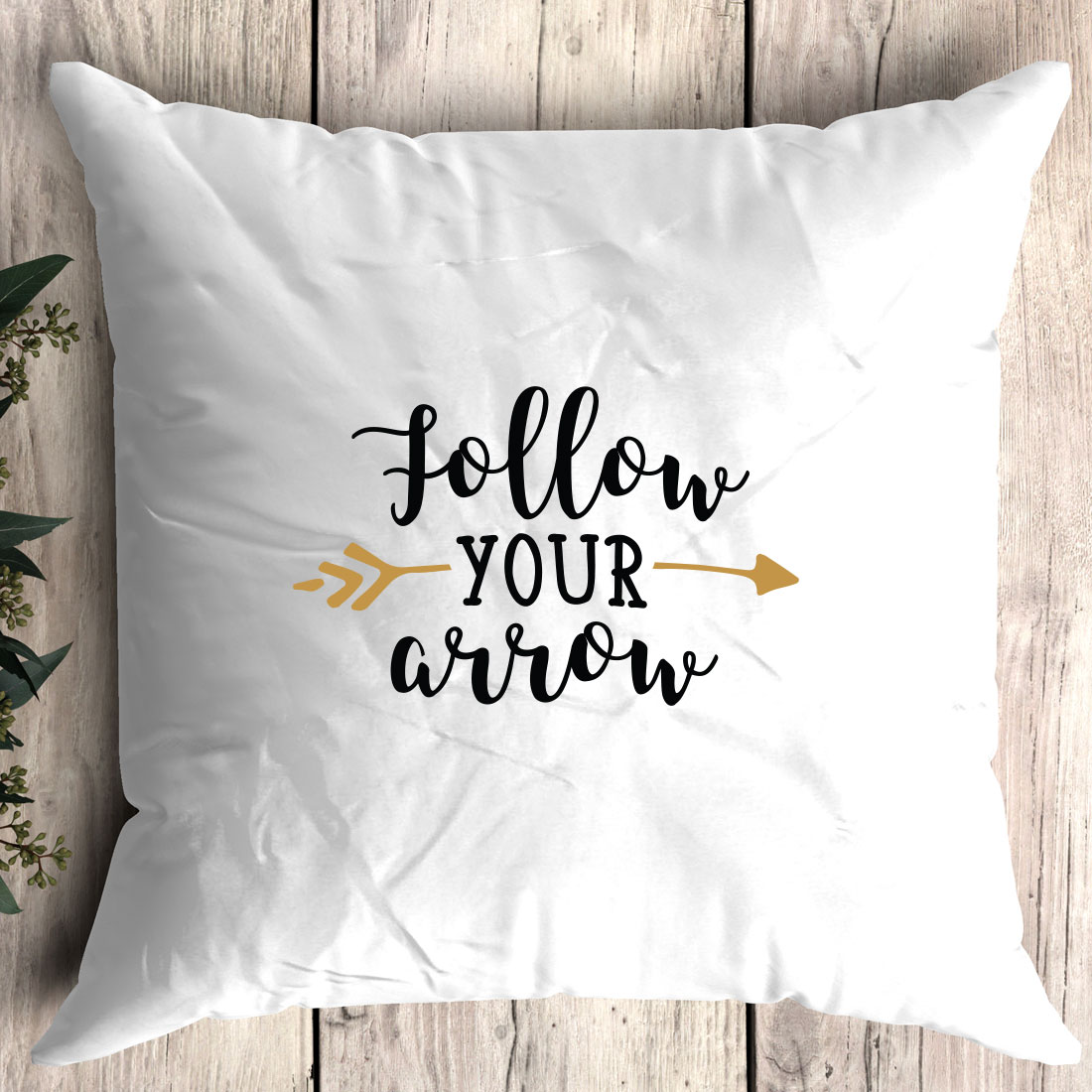 White pillow with the words follow your arrow on it.