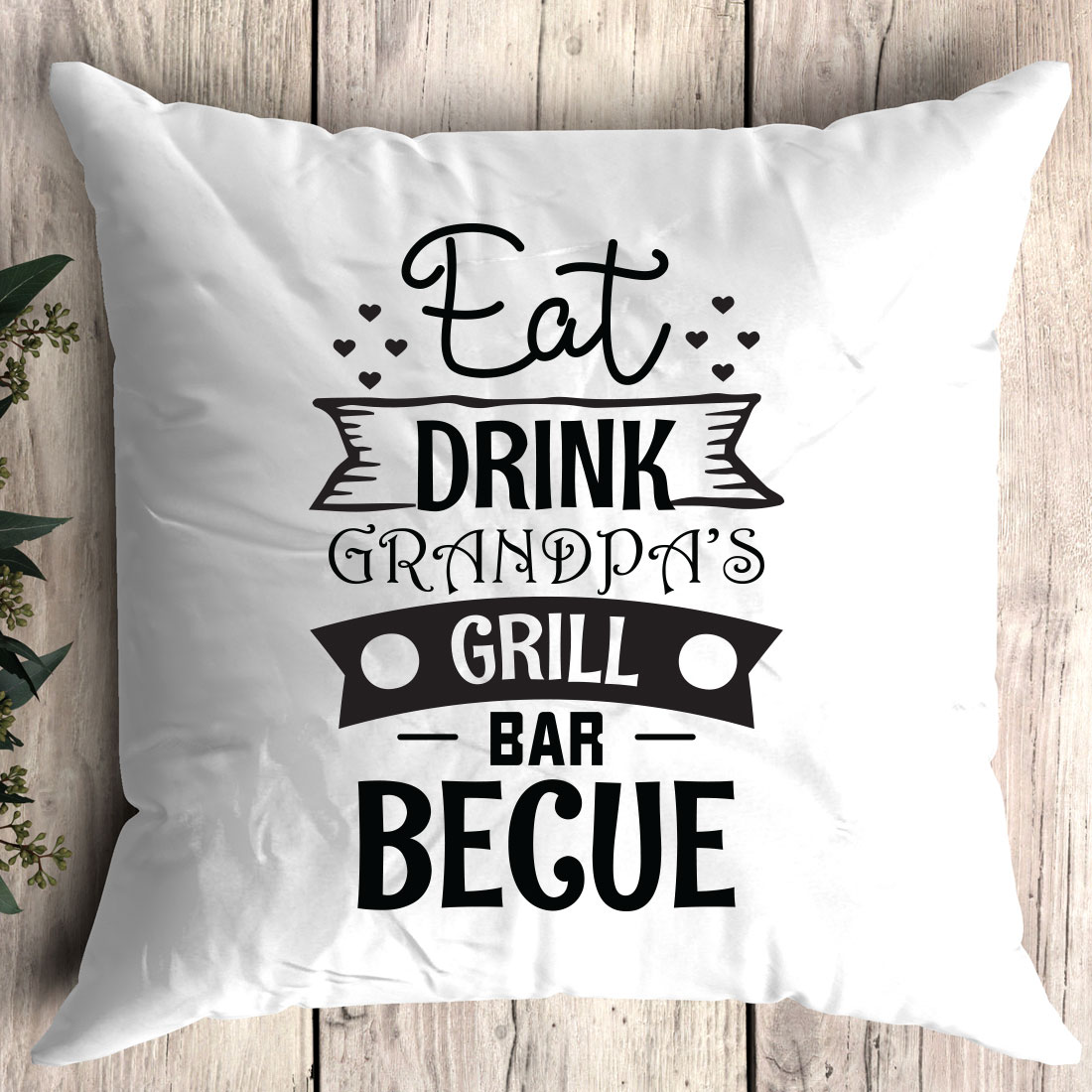 White pillow with the words eat drink and grandpa's grill bar begue.