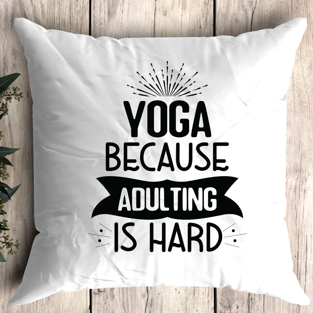 White pillow that says yoga because adulting is hard.