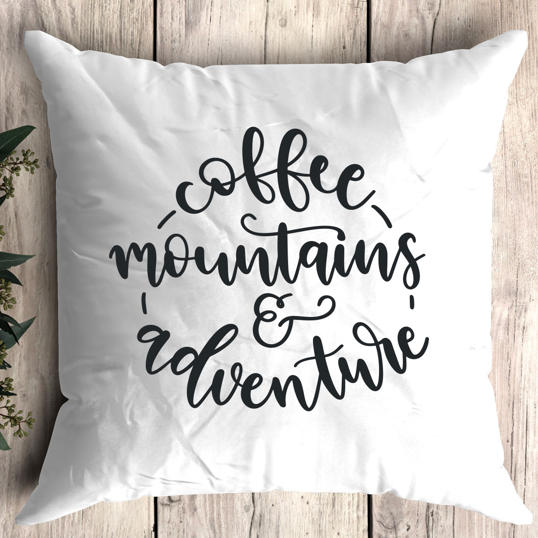 White pillow with the words coffee mountains and adventure on it.